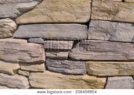Stone wall made with flagstone, decorative rock, building stone and dimensional stone.