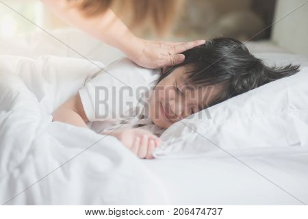 Cute Asian Child Sleeping On White Bed With Mother Care