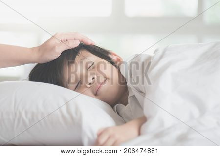 Cute Asian Child Sleeping On White Bed With Mother Care