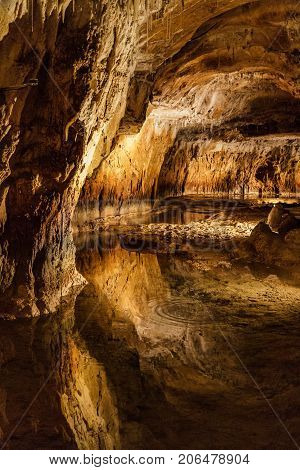 Huge cave with water reflection in france