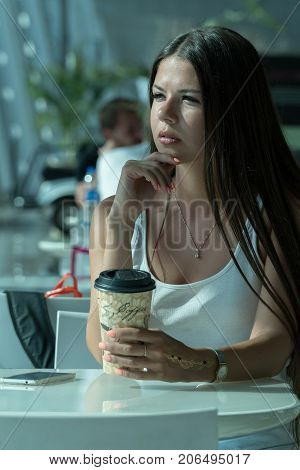 Girl Is Holding A Glass Of Coffee In Airport's Business Lounge With Aircraft