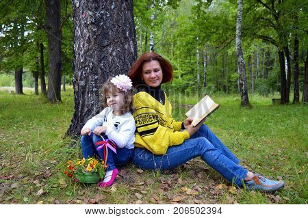 family mom and daughter resting in the forest
