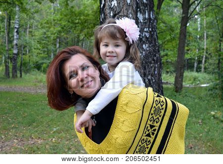family mom and daughter resting in the forest