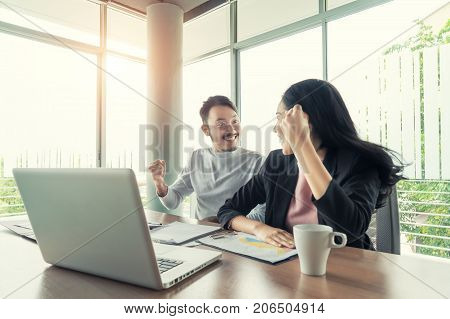 Asian couple business people with casual suit working with happy action in office Business people concept.