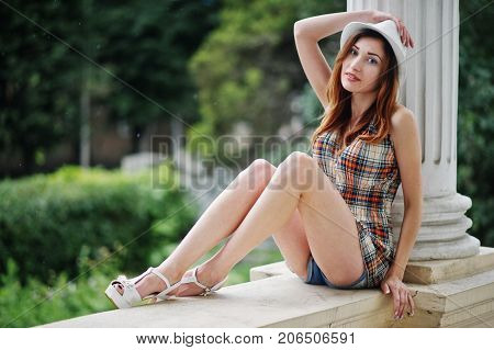 Amazing Long Legs With Hig Heels Girl Wear On Hat Sitting Near Vintage Building Columns.