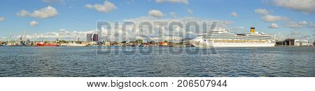 Klaipeda, Lithuania - August 20, 2017: Beautiful view on Klaipeda and Curonian Lagoon from The Curonian Spit, Lithuania. Beautiful summer panorama on Klaipeda, Curonian Lagoon and big cruise ship.