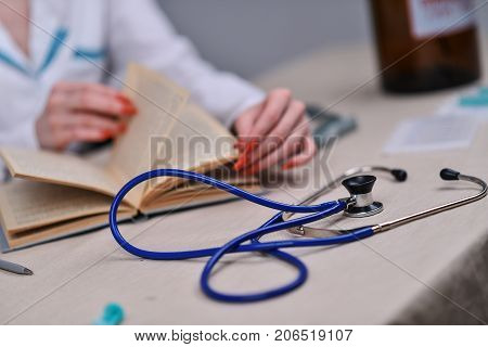 The doctor reads a book in the office