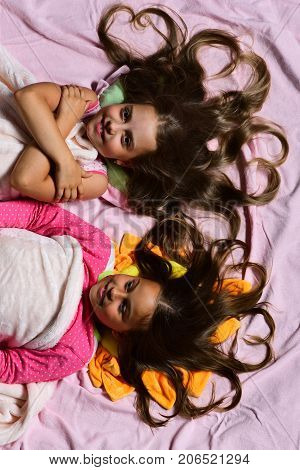 Childhood And Love Concept. Girls On White And Pink Sheets