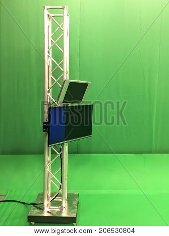 Modern empty green video recording and broadcasting studio with tv channel led screen and metalic stands