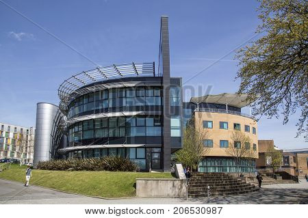 Swansea, UK: May 04, 2016: Swansea University Singleton Campus is set in the grounds of  Singleton Park to the west of Swansea city centre. Students walk past the Digital Technium building which is being considered for demolition to make way for a more 21