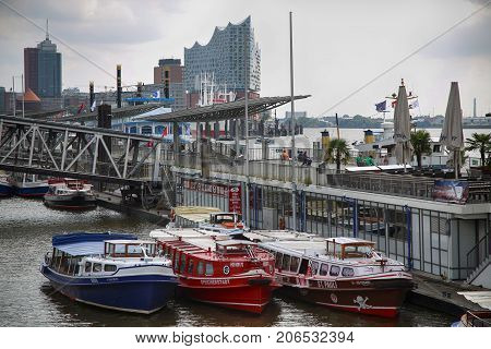 HAMBURG GERMANY - AUGUST 22 2016: Boats and people at the port of Hafencity quarter in Hamburg Germany Hamburg is the second largest city in Hamburg Germany on August 22 2016.