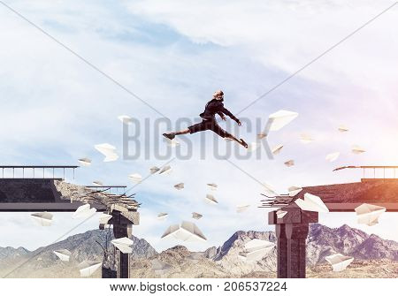 Business woman jumping over gap in bridge among flying paper planes as symbol of overcoming challenges. Skyscape with sunlight and nature view on background. 3D rendering.