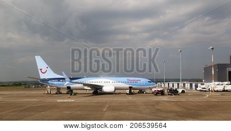Cardiff, UK: May 29, 2016: A Thomson Holidays airplane awaiting baggage loading at Cardiff Airport. Thomson are a UK based holiday travel operator.