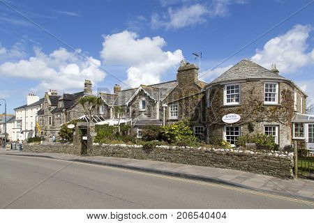 Tintagel, Cornwall, UK: April 14, 2016: The main road through Tintagel with traditional stone built hotels, houses and pubs.