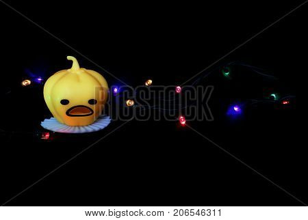 Pumpkin on a black background with lights. Halloween