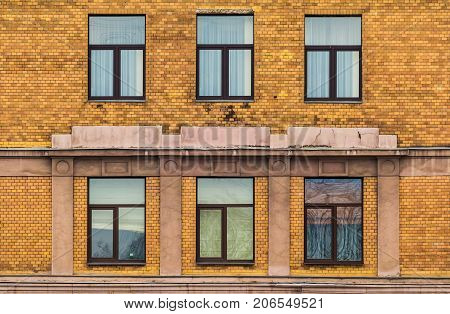 Several windows in a row on facade of urban apartment building front view St. Petersburg Russia
