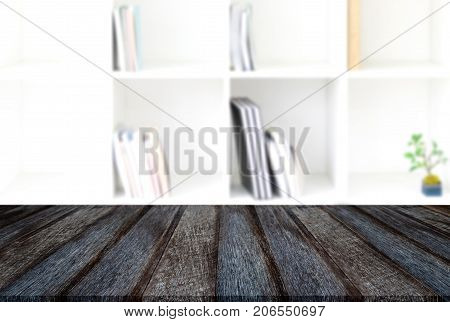 Empty wooden table and blur background of abstract in front of modern library or knowledge source can be used Mock up for display of product or for montage.