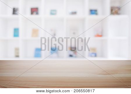 Empty wooden table and blur background of abstract in front of modern library or knowledge source can be used Mock up for display of product or for montage.