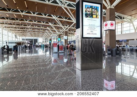 CALGARY CANADA - AUGUST 30 2017: Passengers at the international terminal of Calgary International Airport. Opened in 1938 the airport offers non-stop flights to major cities in North America Europe and East Asia.