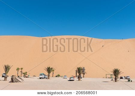 WALVIS BAY NAMIBIA - JULY 2 2017: Picnic spots and unidentified tourists on dune 7 at Walvis Bay in the Namib Desert on the Atlantic Coast of Namibia