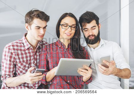 Portrait of caucasian peole using tablet and smartphone. Technology concept