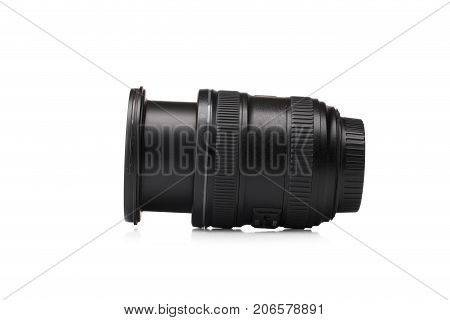 A close-up picture of a black zoom lens isolated on a white background. A professional instrument for taking qualitative photographies. Electronic equipment for photographers. Technology concept.