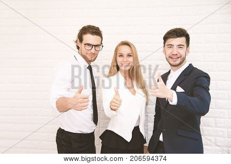 Team workers thumbs up for success in business in front of wall at cafe Business and success concept Teammate and Cooperation Soft tone pinterest and instragram like process.