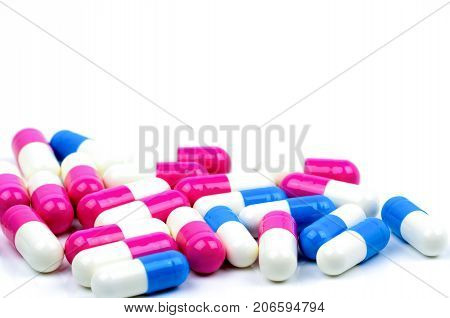 Closeup colorful of antibiotic capsules pills isolated on white background with copy space. Drug resistance antibiotic drug use with reasonable health policy and health insurance concept.