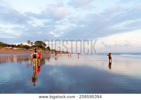 People On Kuta Beach, Seminyak, One Of Popular Attractions In Bali, Indonesia