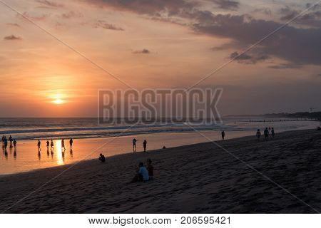 People On Kuta Beach, Seminyak At The Sunset In Bali, Indonesia