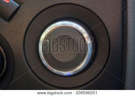 Rounded selector switch in the car. Black selector with chrome edging.