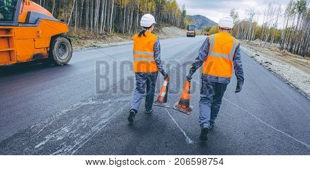 cone worker asphalting construction roller pavement repair