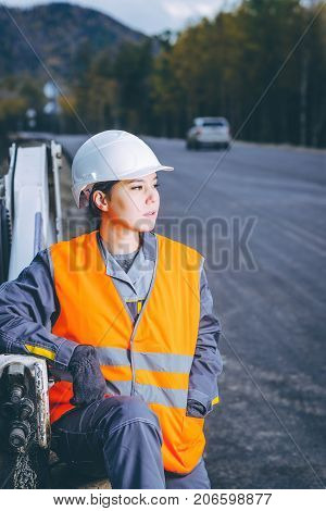 female worker road construction infrastructure repair pavement