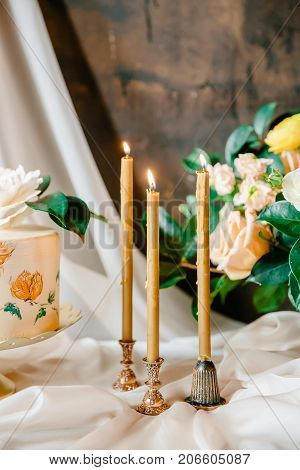 Frowers, candles and wedding painted cake. Still life