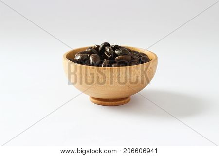 Isolate coffee beans on wooden bowl on white background, Raw and freshness.Closed up.