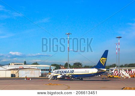 Bologna, Italy - June 30, 2017: Ryanair blue commercial airplane parked at Bologna airport BLQ, with blue sky and copy space. Ryanair is main european low cost flights company.