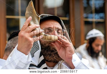 Jewish hasid blows Shofar. Uman Ukraine - 21 September 2017: Rosh Hashanah Jewish New Year.