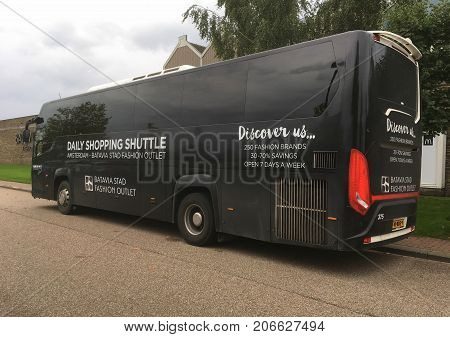 Lelystad, The Netherlands - September 30, 2017: Batavia Stad Fashion Outlet Shopping Shuttle touringcar (Jan de Wit) parked by the side of the road in the city of Lelystad. Nobody in the vehicle.