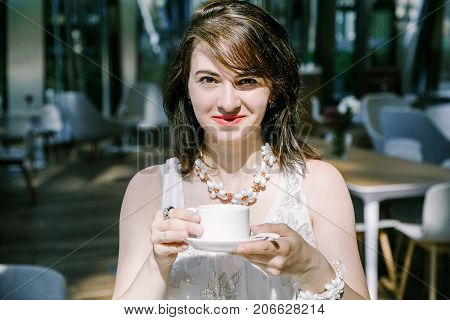The Girl Drinks  Coffee During.