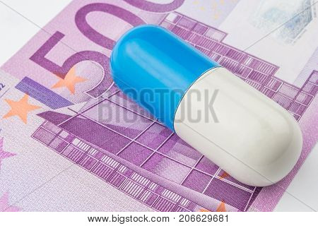One Big Blue And White Pill Is Laying On 500 Euro Banknote