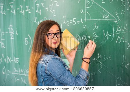 Girl with green baord behind