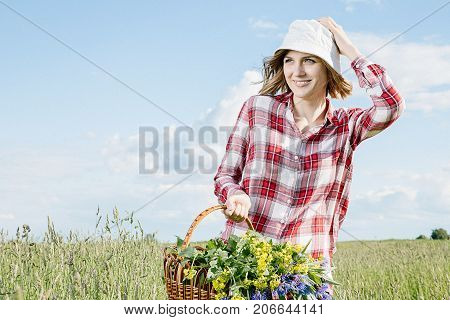 Girl With A Basket Of Flowers In The Field.