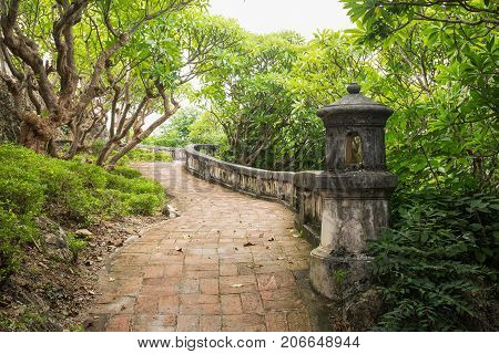 vintage walkway surround with verdant plant of Phra Nakhon Khiri historical park at Petchaburi Thailand