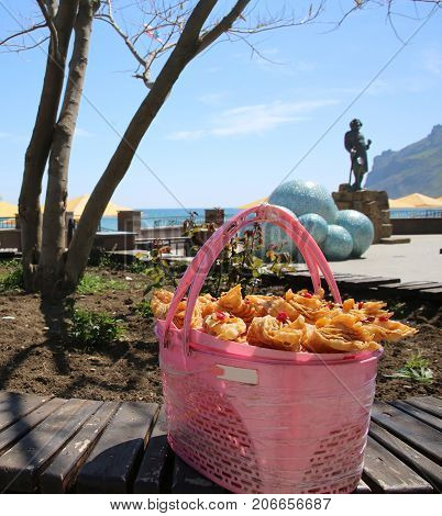 Cake brushwood in the basket on the seashore