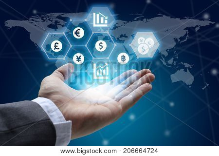 hand holding global network using Currencies sign symbol interface of Fintech over the Network connection of World map background Investment Financial Technology Concept.