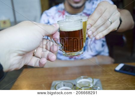 Two Men Toasting (cheers!) Over Mini Beer