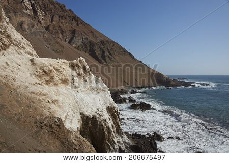 Anzota Caves at Arica on the coast of Chile. The area was used as a settlement by the Chinchorro people and later mined for guano deposited on the cliffs.