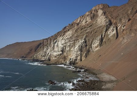 Anzota Caves at Arica on the coast of Chile. The area was used as a settlement by the Chinchorro people and later mined for guano deposited on the cliffs.