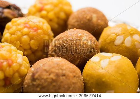 Stock photo of variety of sweet laddu or laddoo or ladu, a sweet dumpling made up of bundi, dry fruits or rava, selective focus