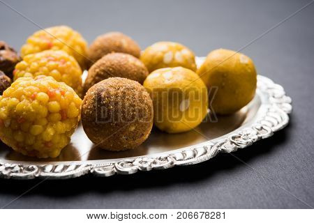 Stock photo of variety of sweet laddu or laddoo or ladu, a sweet dumpling made up of bundi, dry fruits or rava, selective focus